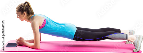 Fit woman doing plank on mat