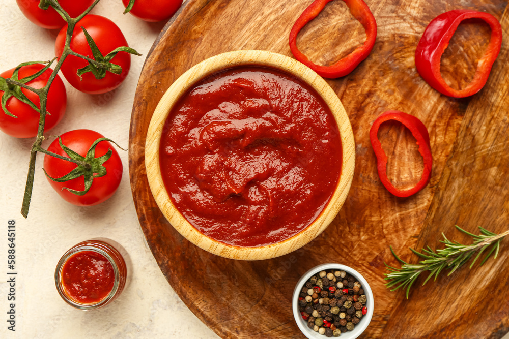 Tray with bowl of tasty tomato paste, spices and fresh vegetables on light background Tray with bowl of tasty tomato paste, spices and fresh vegetables on light background
