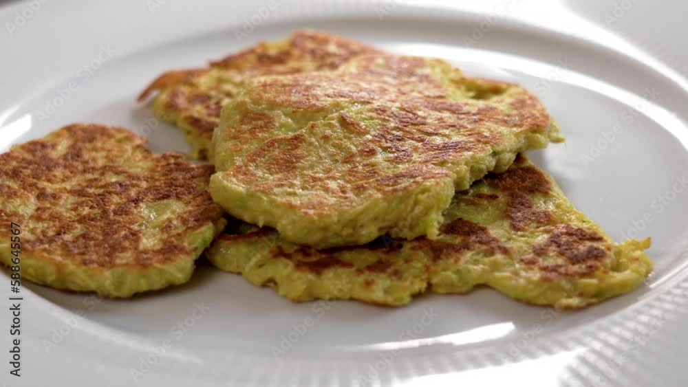 Baked vegetable dietary fritters on a white plate close up Baked vegetable dietary fritters on a white plate close up