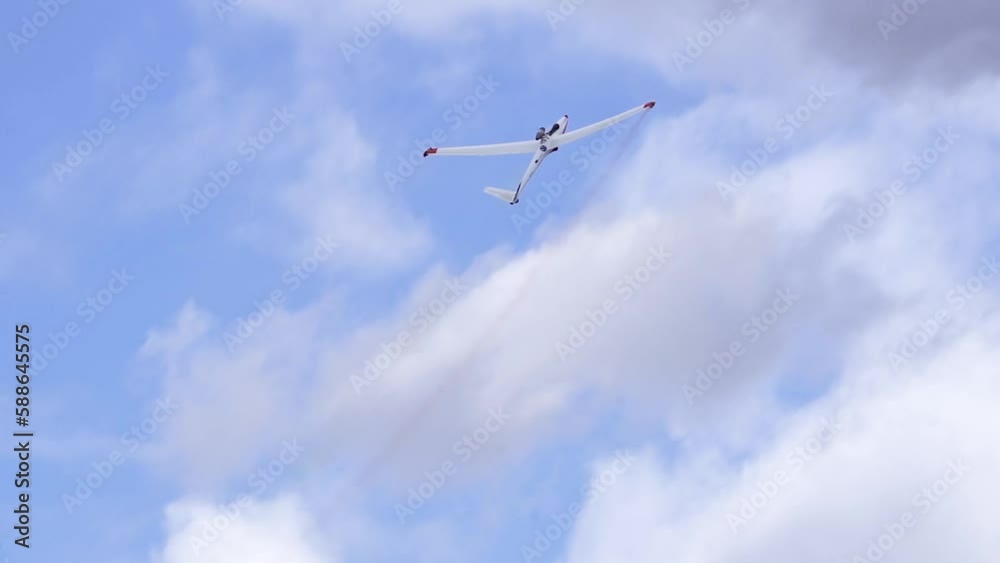 Jet Powered Sailplane Flying Up In The Cloudy Sky - low angle Jet Powered Sailplane Flying Up In The Cloudy Sky - low angle