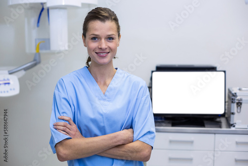 Portrait of dental assistant standing with arms crossed