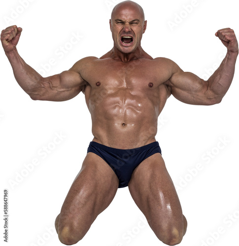 Aggressive man showing muscular build while kneeling 