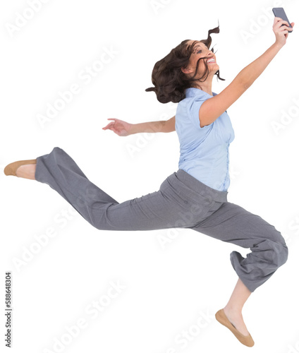 Happy classy businesswoman jumping while holding smartphone