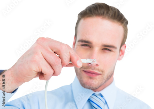 Concentrated businessman holding a cable