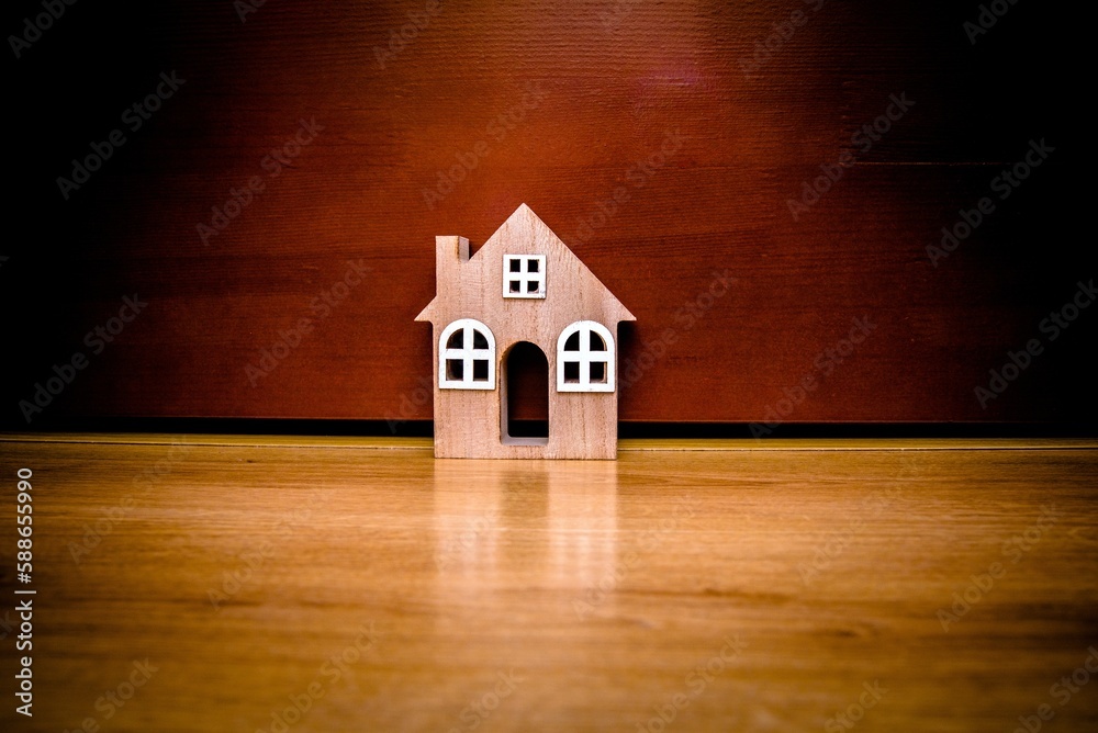 House symbol on a brown wooden background
House symbol on a brown wooden background