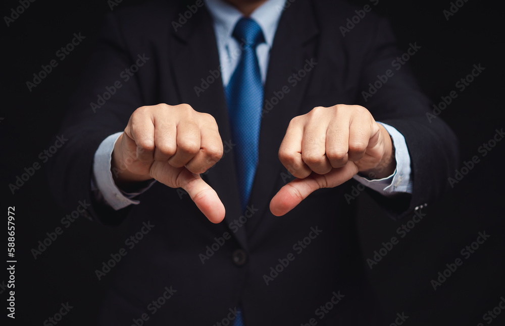 Negative concept. Close-up of businessman's hands showing a thumbs down for dislike service