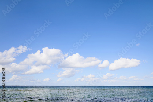 Blue sky and clouds by the sea on a sunny day