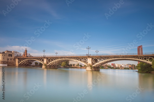 Triana Bridge is a metal arch bridge in Seville Spain that connects the Triana neighbourhood with the centre of the city