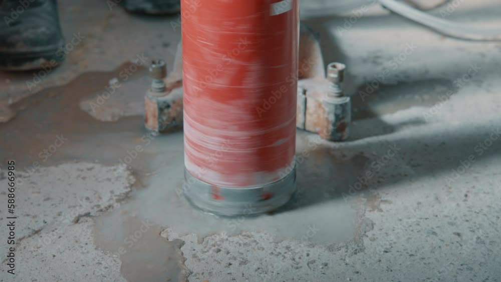 4K video of drilling a hole into a concrete floor with core driller
