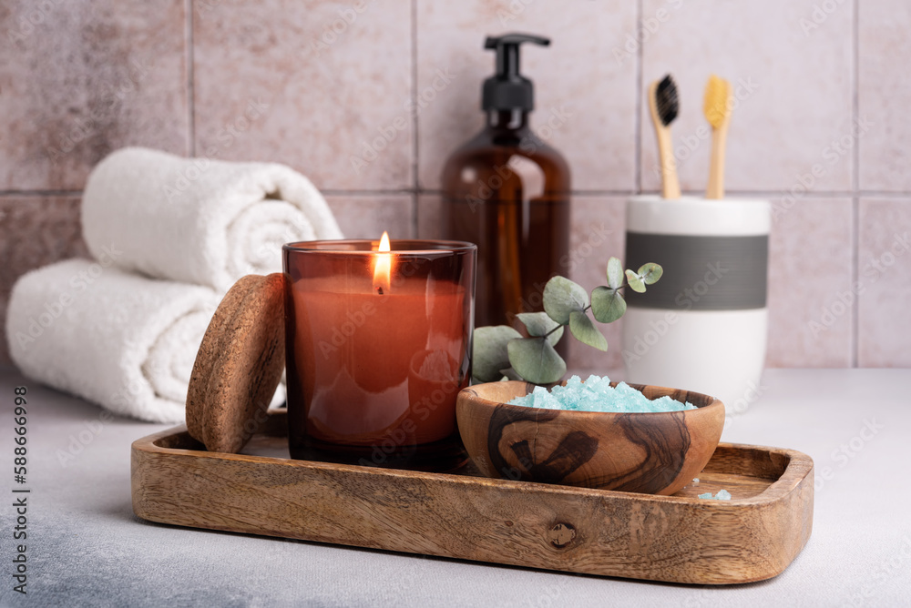Scented candle, sea salt and bathroom accessories