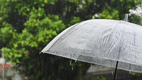 Holding an umbrella in the pouring rain