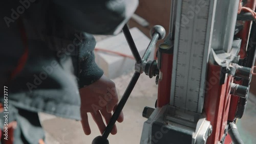 4K video of drilling a hole into a concrete floor with core driller