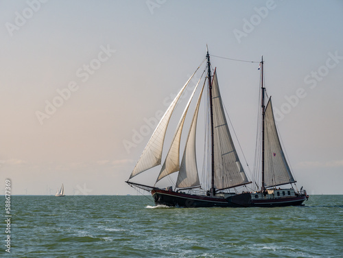 Traditional two-masted clipper sailing on IJsselmeer lake  Netherlands