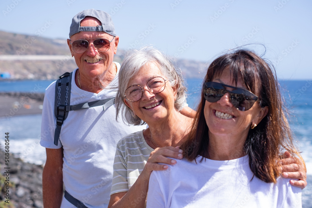 Cheerful Group of Elderly People Standing close to the Beach Enjoying Sea Vacation and Freedom. Retirement Lifestyle Concept Cheerful Group of Elderly People Standing close to the Beach Enjoying Sea Vacation and Freedom. Retirement Lifestyle Concept