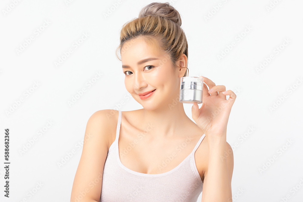 Happy beautiful young asian woman holding cosmetic cream blank bottle, Fashion model, Health wellness, Beautiful girl skin care and facial treatment. Isolated on white background.