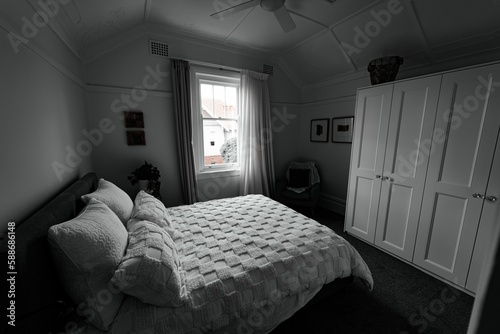 View of sunlight illuminating a white-furnished bedroom