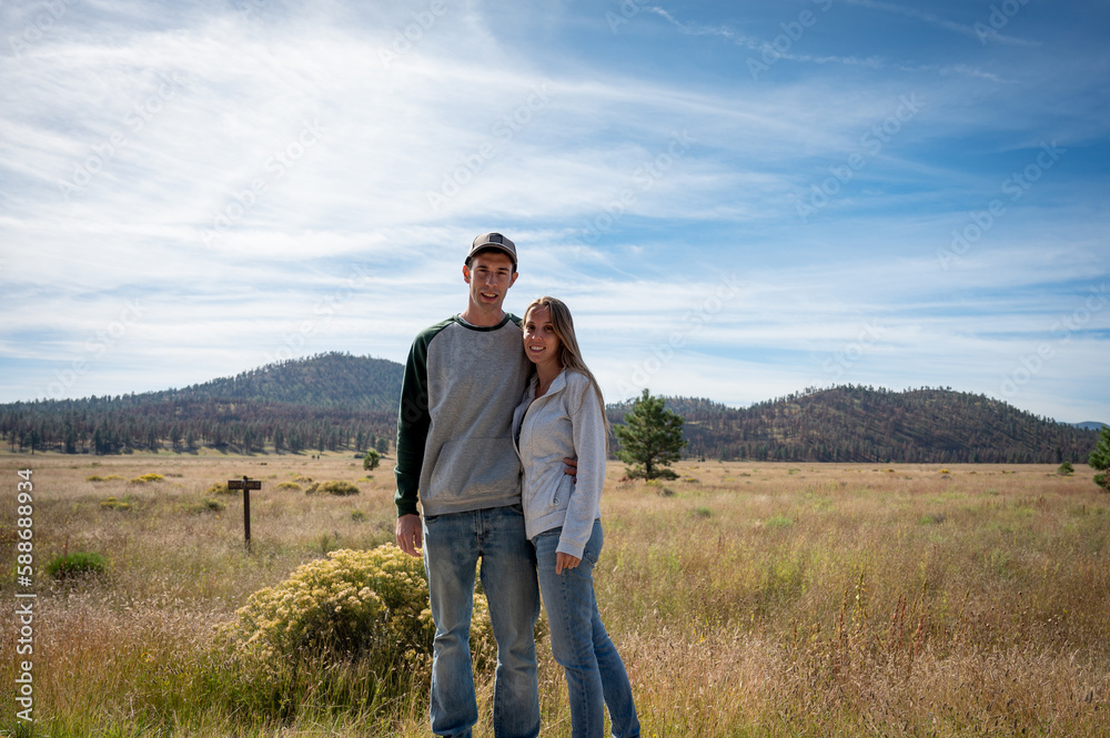 Young wedding couple in love together on the mountain plain