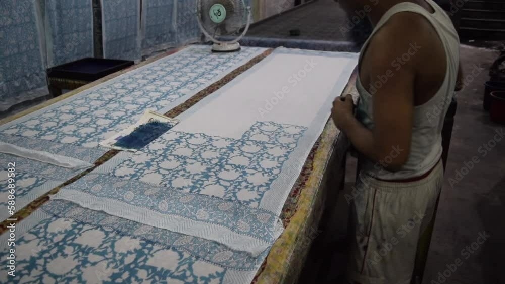 Southeast Asian man printing textile manually in Jaipur, India