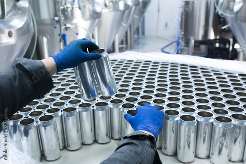 Wallpaper Mural drink production manufactrure, worker's hand taking new aluminium cans Torontodigital.ca