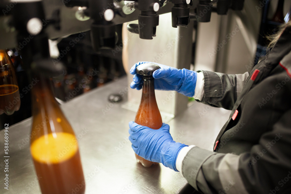 Naklejka premium Manufacture worker install new plastic bottle cap