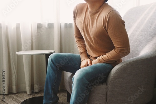 Man using his hands touching and covering his crotch suffering from his genitourinary system or genital organ problem Man healthcare and urinary incontinence concept