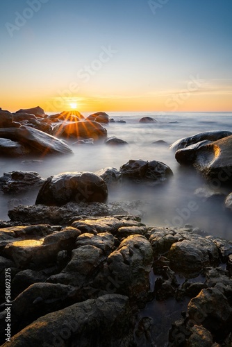 Vertical shot of the rocky coast in Khlong Chao beach, Thailand on sunset