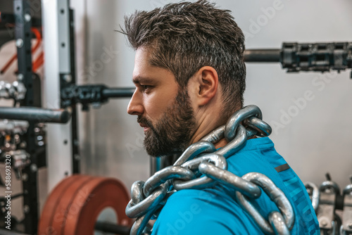 Sportsman working with heavy weights in a gym
