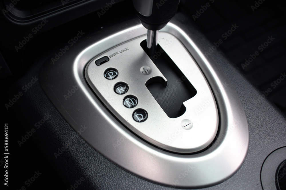 Car gear stick on parking mode, Mechanism of switching modes of automatic transmission car. Leather black interior. Car drive mode selector. Suspension and wheel drive control panel. Car gear stick on parking mode, Mechanism of switching modes of automatic transmission car. Leather black interior. Car drive mode selector. Suspension and wheel drive control panel.