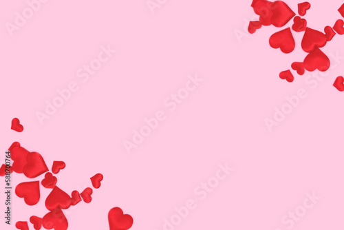 Frame made of red textile hearts confetti scattered on a pink background.