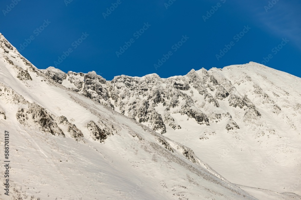Winter mountains covered in snow against the blue sky in Orskogfjellet, Tresfjorden, Vestnes