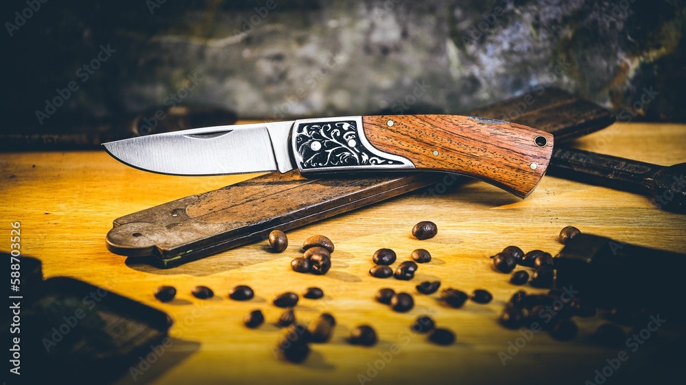 Opened pocket knife over a vintage ruler on the wooden surface - obrazy, fototapety, plakaty 