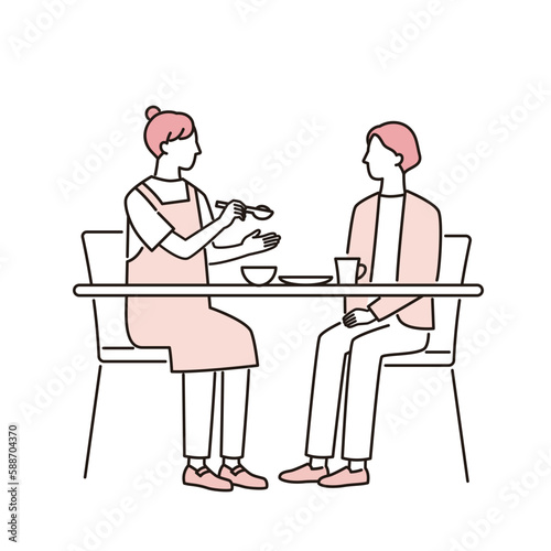 食事をする女性と介助する介護福祉士
