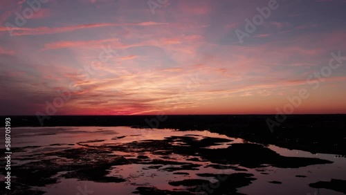 Drone shot of the breathtaking purple sky at sunset over lake Tohopekaliga in Kissimmee, Florida photo
