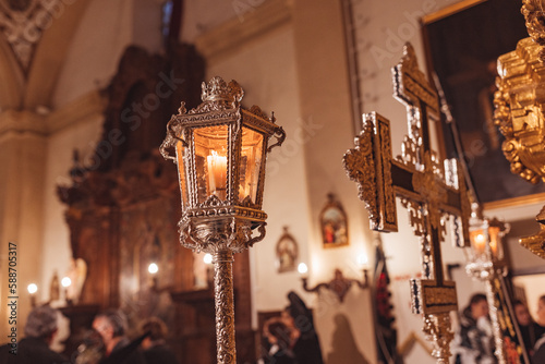 Cross and lighted lantern inside a church