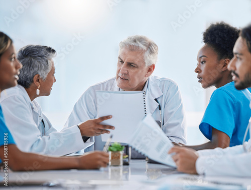 Teamwork, meeting and doctors in discussion with documents for medical strategy, research and consulting. Healthcare, collaboration and people talking for insurance, planning and surgery results © Tamline L/peopleimages.com