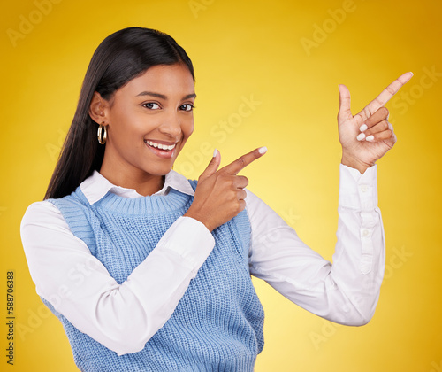 Woman  portrait and gun fingers in a studio pointing with emoji hand gesture with a smile. Happiness  business female and happy youth with proud and cool hands sign in isolated yellow background