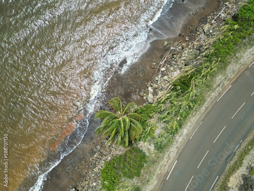 Aerial top view shot of a highway and the ocean in Houailou, New Caledonia photo