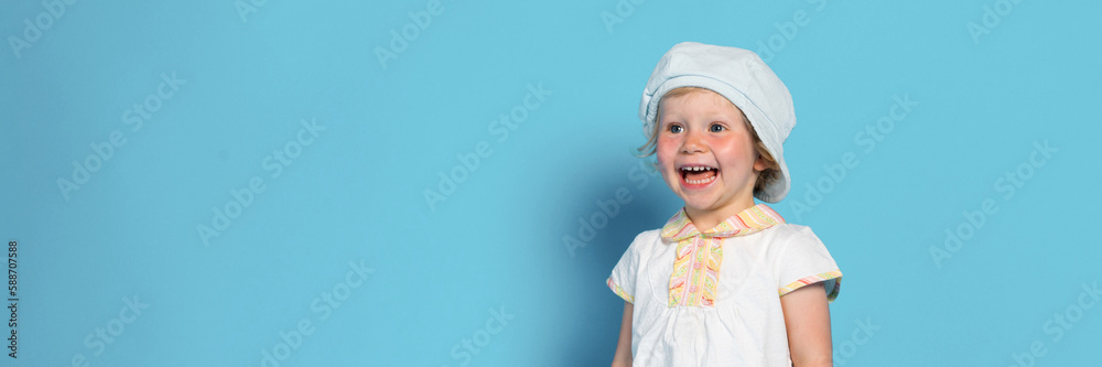 Portrait of beautiful little girl against blue background Portrait of beautiful little girl against blue background