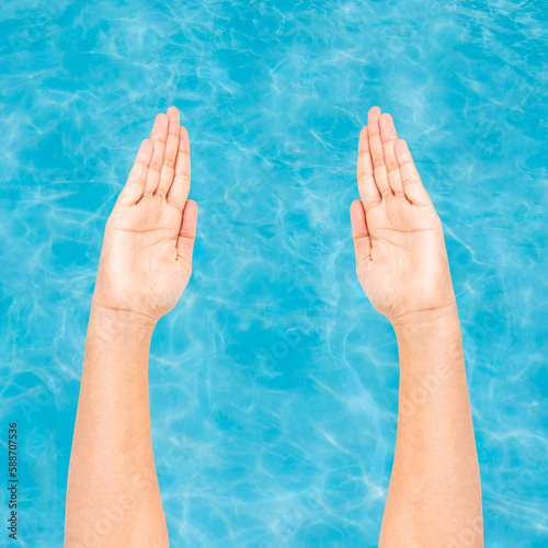 Hands preparing to swim with water background