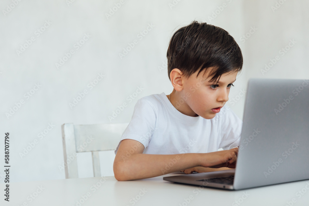 education online online games classes boy sitting at a laptop at school education online online games classes boy sitting at a laptop at school