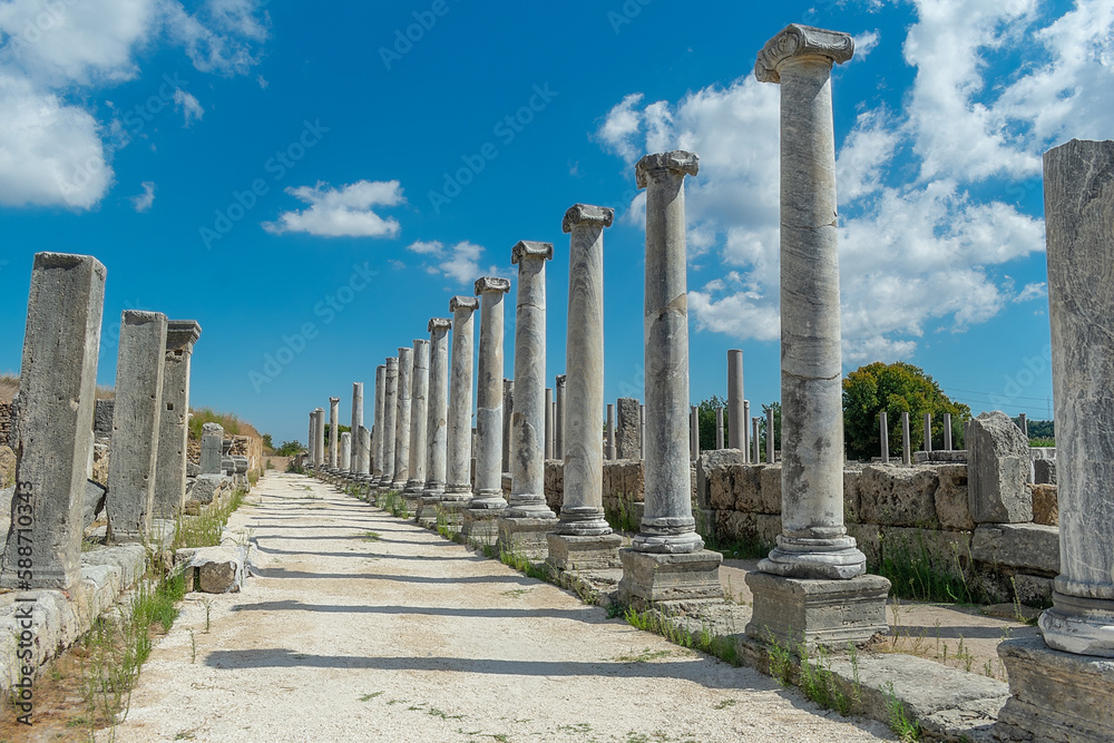 Agora of the ancient city of Perge in clear sunny weather. Against the background of a blue sky with clouds.