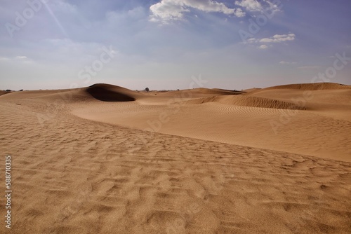 Sand in the dry desert on a sunny day against a blue sky