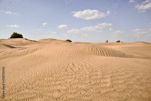 Beautiful shot of a dry brown desert under a bright blue sky