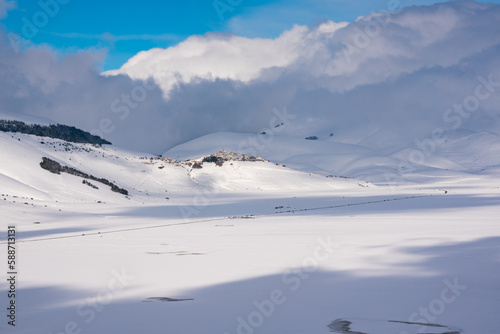 Winter landscape, small town on a hill in a valley covered with snow
