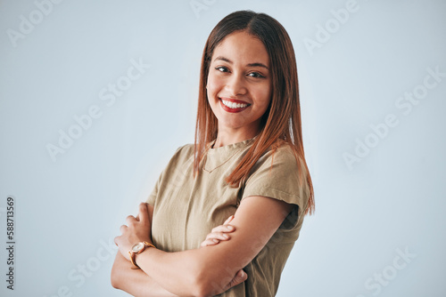 Woman, proud portrait and happiness with arms crossed of a gen z female in a studio with gray background. Isolated, happy and smile from a person feeling motivation, youth and confidence with pride © Talia Mdlungu/peopleimages.com