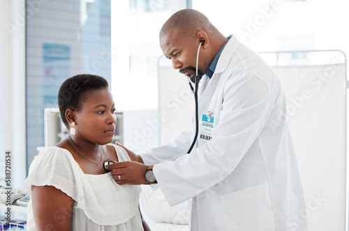 Healthcare, doctor listening to patient heart with stethoscope and medical consultation with black people. Cardiovascular medicine, man with woman in hospital and health insurance with examination