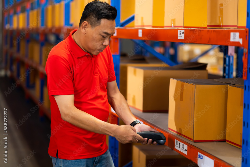 Warehouse manager staff working on barcode scanner handheld at