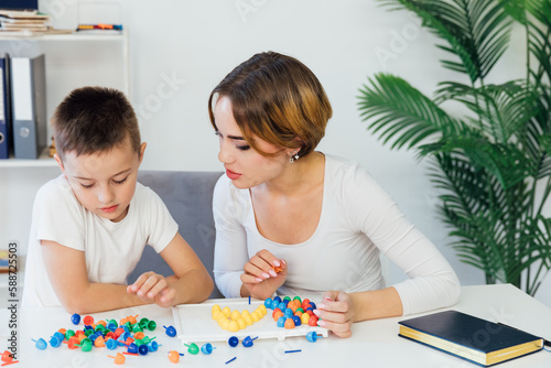 educational games for children a child psychologist is engaged with a boy in the office