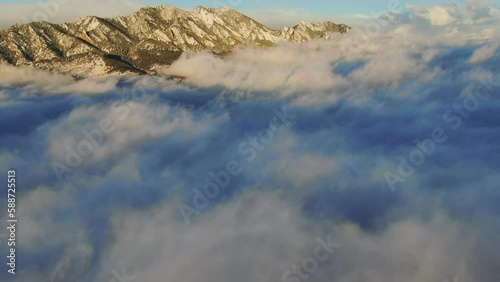 Wave of clouds Pan up sunrise above the clouds flying Boulder Flat Irons freezing cold winter orange drone aerial Colorado photo