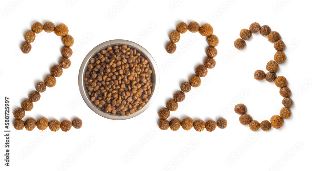 Calendar 2023 from Dry pet food and a bowl full of crispy granules on a white background. Calendar 2023 from Dry pet food and a bowl full of crispy granules on a white background.